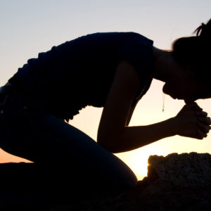 Praying, kneeling silhouette