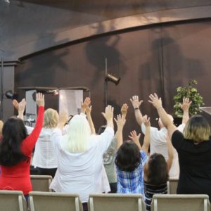 Worshippers raise their hands in prayer