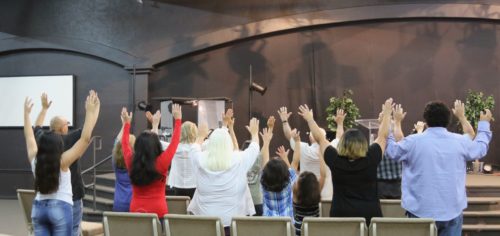Worshippers raise their hands in prayer