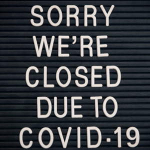 A sign reads `SORRY WE'RE CLOSED DUE TO COVID-19`