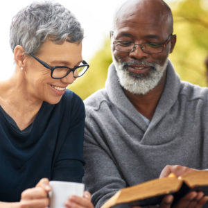 An older couple reads a bible together