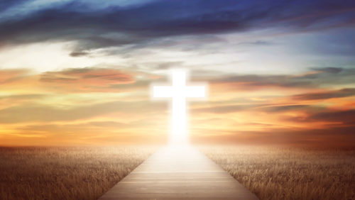 A glowing path leads to a glowing cross, under a turbulent sky