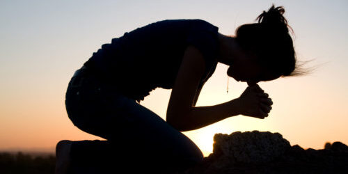 Praying, kneeling silhouette
